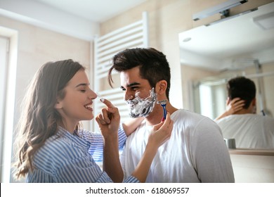 A Handsome Young Man Shaving In The Bathroom.