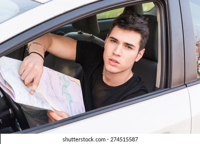 Handsome Young Man Showing Map Inside Of A Car, Asking For Directions