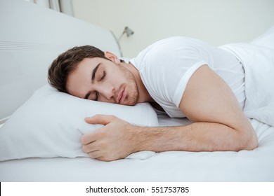 Handsome Young Man Sleeping On Pillow In Bed