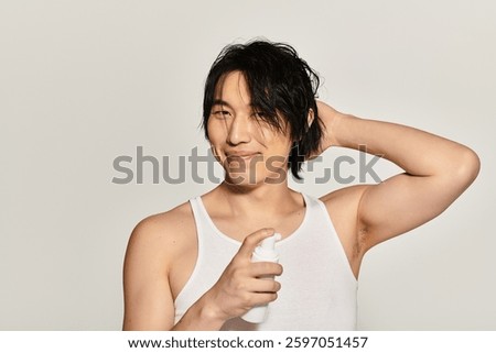 Handsome young man smiling while applying a grooming product, exuding confidence and style.