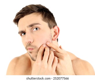 Handsome Young Man Squeezing Pimple Isolated On White