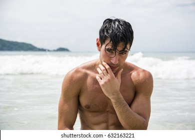 Handsome Young Man Standing On A Beach In Phuket Island, Thailand, Shirtless Wearing Boxer Shorts, Showing Muscular Fit Body