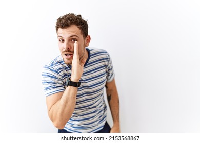 Handsome Young Man Standing Over Isolated Background Hand On Mouth Telling Secret Rumor, Whispering Malicious Talk Conversation 