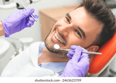 Handsome young man in stomatology clinic. Dental care - Powered by Shutterstock