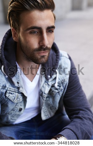 Similar – Guy with beard and modern hairstyle in urban background.