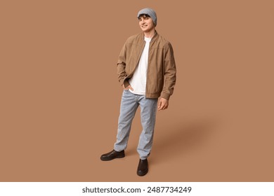 Handsome young man in stylish clothes on brown background - Powered by Shutterstock