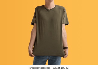 Handsome young man in stylish t-shirt on orange background - Powered by Shutterstock