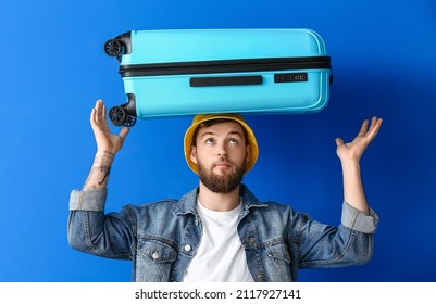 Handsome Young Man With Suitcase On Blue Background