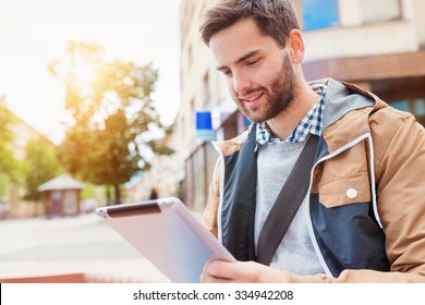 Handsome Young Man With Tablet Outside In The Town