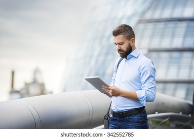 Handsome young man with tablet in the streets of London - Powered by Shutterstock