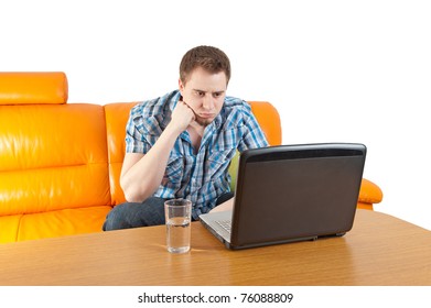 Handsome young man thinking over a laptop