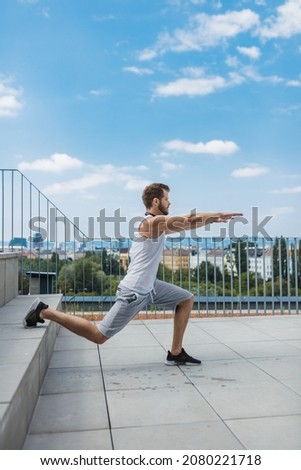 Similar – Athletic man warming up before running.