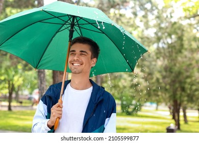 Handsome Young Man With Umbrella In Park