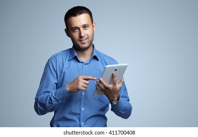 Handsome young man using a digital tablet in her hands. Internet technologies. Business negotiations. Business lifestyle. Digital communication