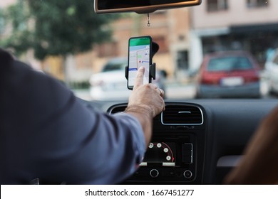 Handsome Young Man Using Smart Phone Navigation Application.