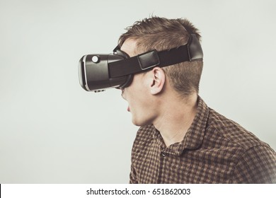 Handsome Young Man Using Virtual Reality Headset. Using Smartphone With VR Glasses. The Immersion in the Virtual World!