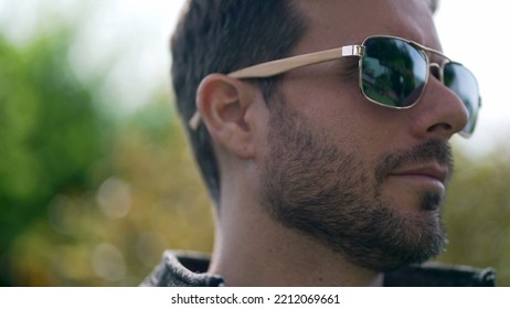 Handsome Young Man Wearing Sunglasses Outdoors. Closeup Face Of Male Person With Eye Glass