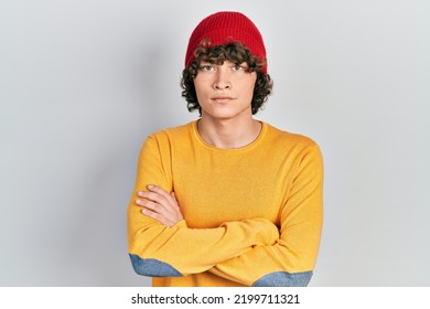 Handsome young man wearing wool hat skeptic and nervous, disapproving expression on face with crossed arms. negative person.  - Shutterstock ID 2199711321