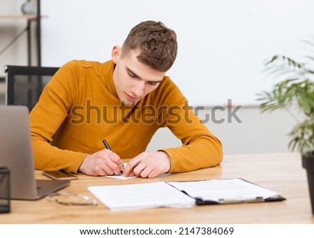 handsome young man working with documents in the office