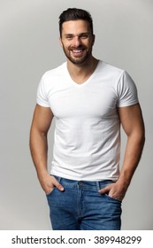 Handsome Young Man,boy,posing In White T Shirt And Jeans With Hands In Pockets