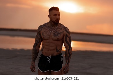 Handsome Young Muscular Italian Man Posing Shirtless On The Beach, Sunset Summer Time. Ideal Fit Body.