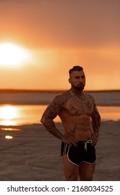 Handsome Young Muscular Italian Man Posing Shirtless On The Beach, Sunset Summer Time. Ideal Fit Body.