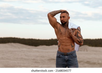 Handsome Young Muscular Italian Man Posing Shirtless On The Beach, Sunset Summer Time. Ideal Fit Body.