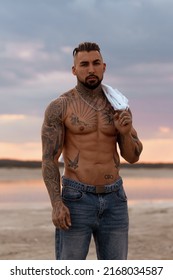 Handsome Young Muscular Italian Man Posing Shirtless On The Beach, Sunset Summer Time. Ideal Fit Body.