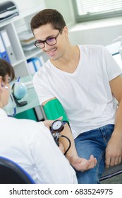 Handsome Young Patient Getting His Blood Pressure Checked