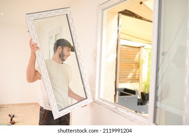 Handsome Young Professional Man Installing And Replacing A New Home Windows In Client House For Improvement Energy Saving Efficiency Isolation