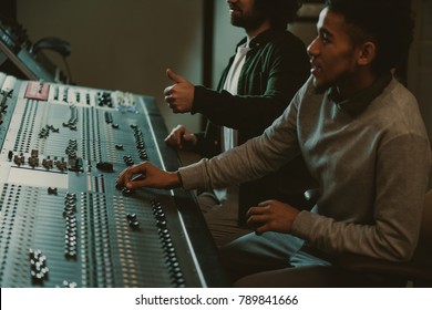 handsome young sound producers at recording studio - Powered by Shutterstock