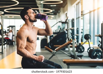 Handsome Young Sporty Male Bodybuilder Drinking Water While Resting Between Exercises