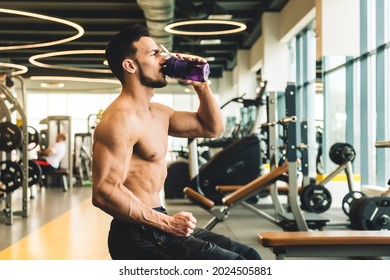 Handsome Young Sporty Male Bodybuilder Drinking Water While Resting Between Exercises