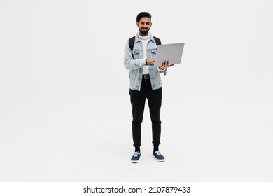 A Handsome Young Student Using Laptop And Carrying Backpack Isolated On White Background