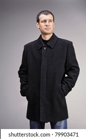 Handsome Youthful Man In The Studio Dressed In Black Wool Coat