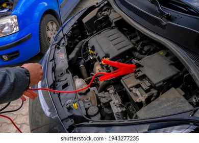 Hands-on Open Hood. Charging The Car Battery. Open Hood At Service Station Close-up. Car Open Bonnet Top View