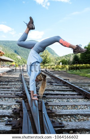 Handstand on train tracks.