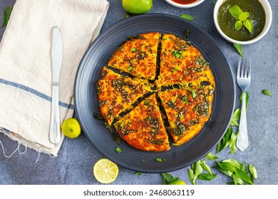 Handvo is a savory Indian cake made from fermented rice and lentil batter, mixed with vegetables and spices. Selective Focus.  - Powered by Shutterstock