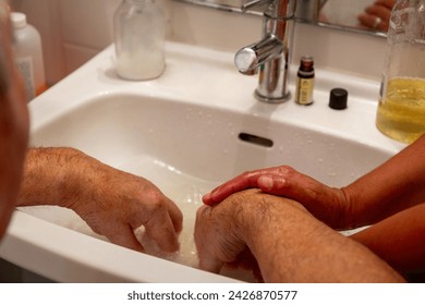 Handwashing and comfort of an elderly person by home health aide - Powered by Shutterstock