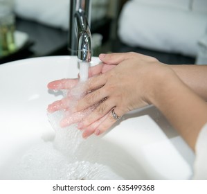 Hand,washing. woman washing hands under a tap water,Washing Hands with streaming water under tap in bathroom. Hygiene
