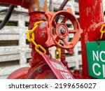 Handwheel valve with signage on fire fighting piping system.