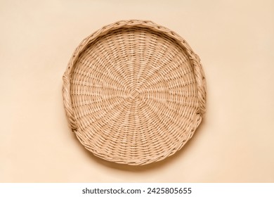 Handwoven Eco-Friendly Tray: Top View of Handcrafted Rattan and Paper Wicker Serving Tray on Beige Surface - Powered by Shutterstock