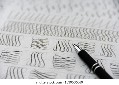 Handwriting calligraphy sheets. Design elements and pen close up. Handwritig day concept