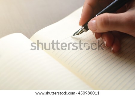 handwriting, hand writes a pen in a notebook