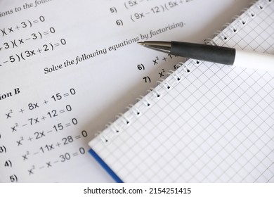 Handwriting of mathematics quadratic equation on examination, practice, quiz or test in maths class. Solving exponential equations background concept.