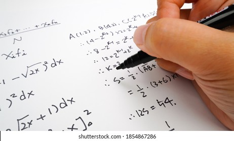 Handwriting To Solve Math Formulas Holding A Computer Pen. Math Formulas Solves The Test, Practice, Test Or Exam, Background Concept In Math Class.
