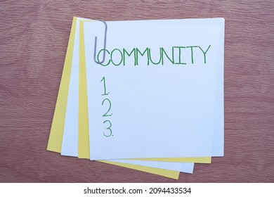 Handwriting text Community. Business idea group of showing with a common characteristics living together Multiple Assorted Collection Office Stationery Photo Placed Over Table
