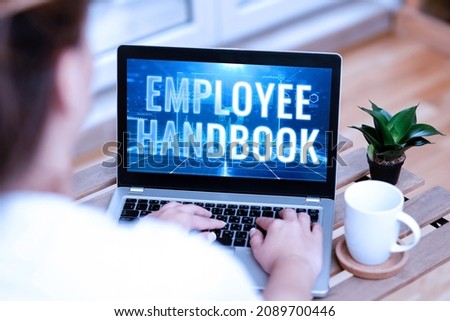 Handwriting text Employee Handbook. Concept meaning Document that contains an operating procedures of company Woman Typing On Laptop Beside Coffe Mug And Plant Working From Home.