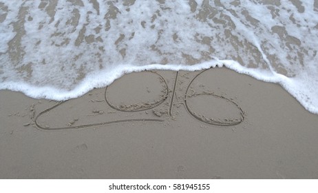 Handwriting words "2016" on sand of beach  