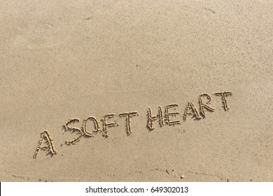 Handwriting  words "A SOFT HEART" on sand of beach. - Shutterstock ID 649302013